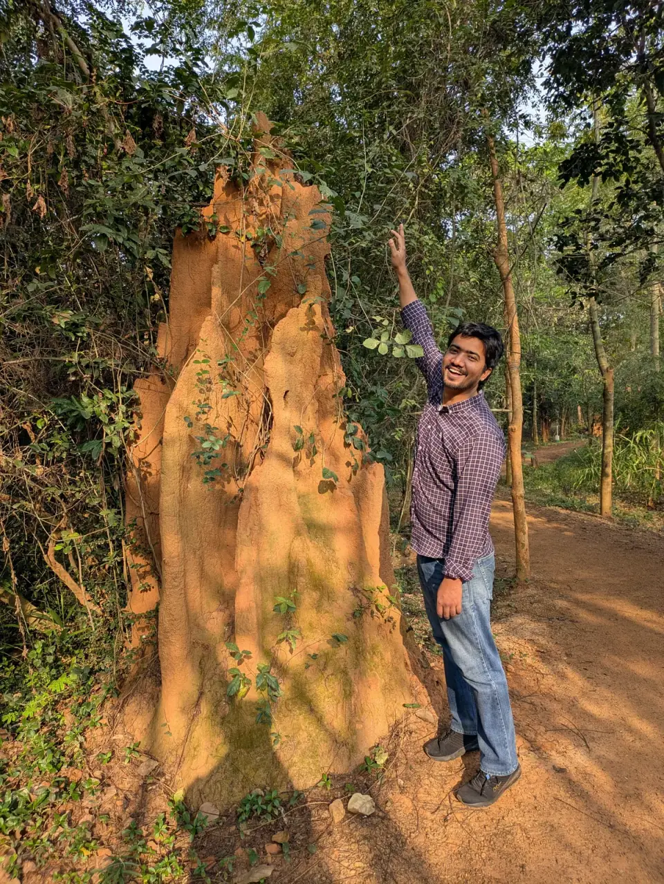 Rohit Kumar, trying to compare his height with a tall anthill